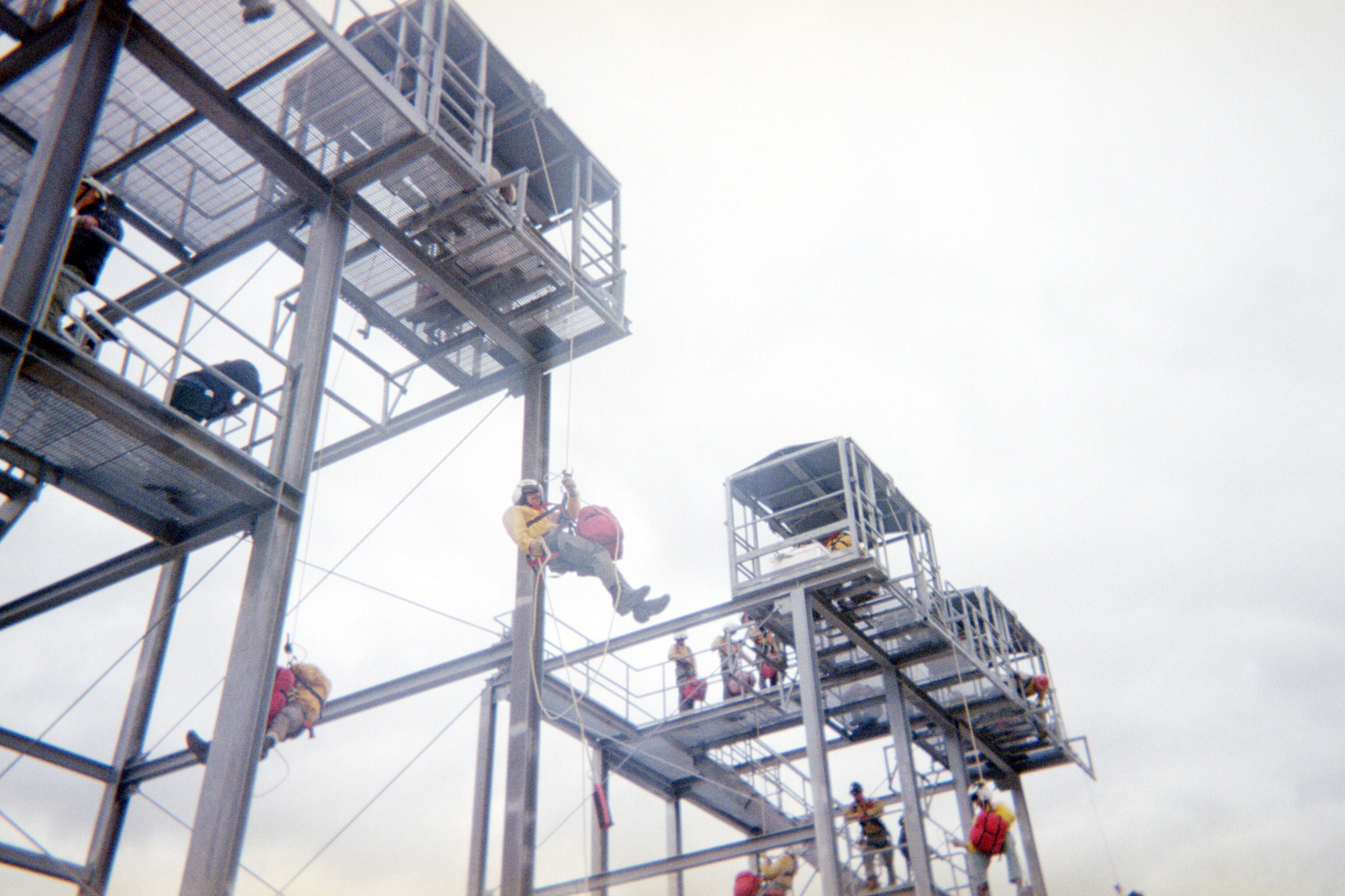 Rookie Rappellers train on rappel towers at the National Rappel Academy in Salmon, Idaho, developing the skills required for USFS helicopter rappel and wildland fire operations.