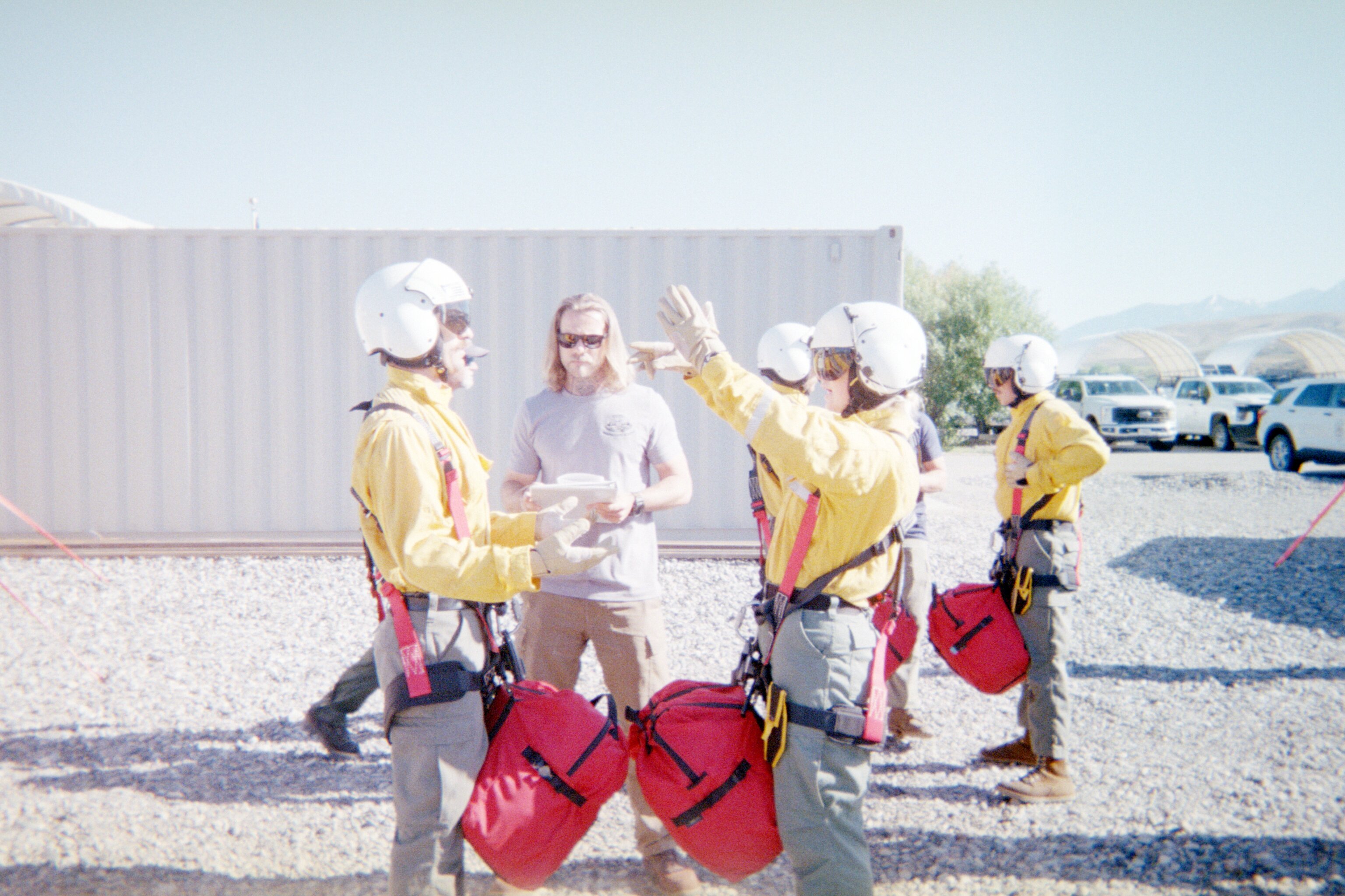 North Idaho Rappellers rookies review rappel equipment, buddy checks, and procedures during hands-on training at the National Rappel Academy in Salmon, Idaho.