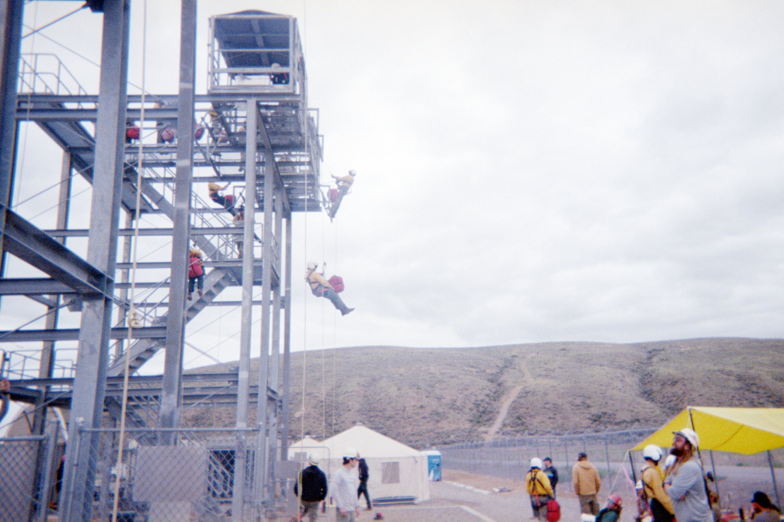 Rookie heli-rappellers practice controlled tower descents at the National Rappel Academy, building the technical skills required for wildland fire aviation operations.