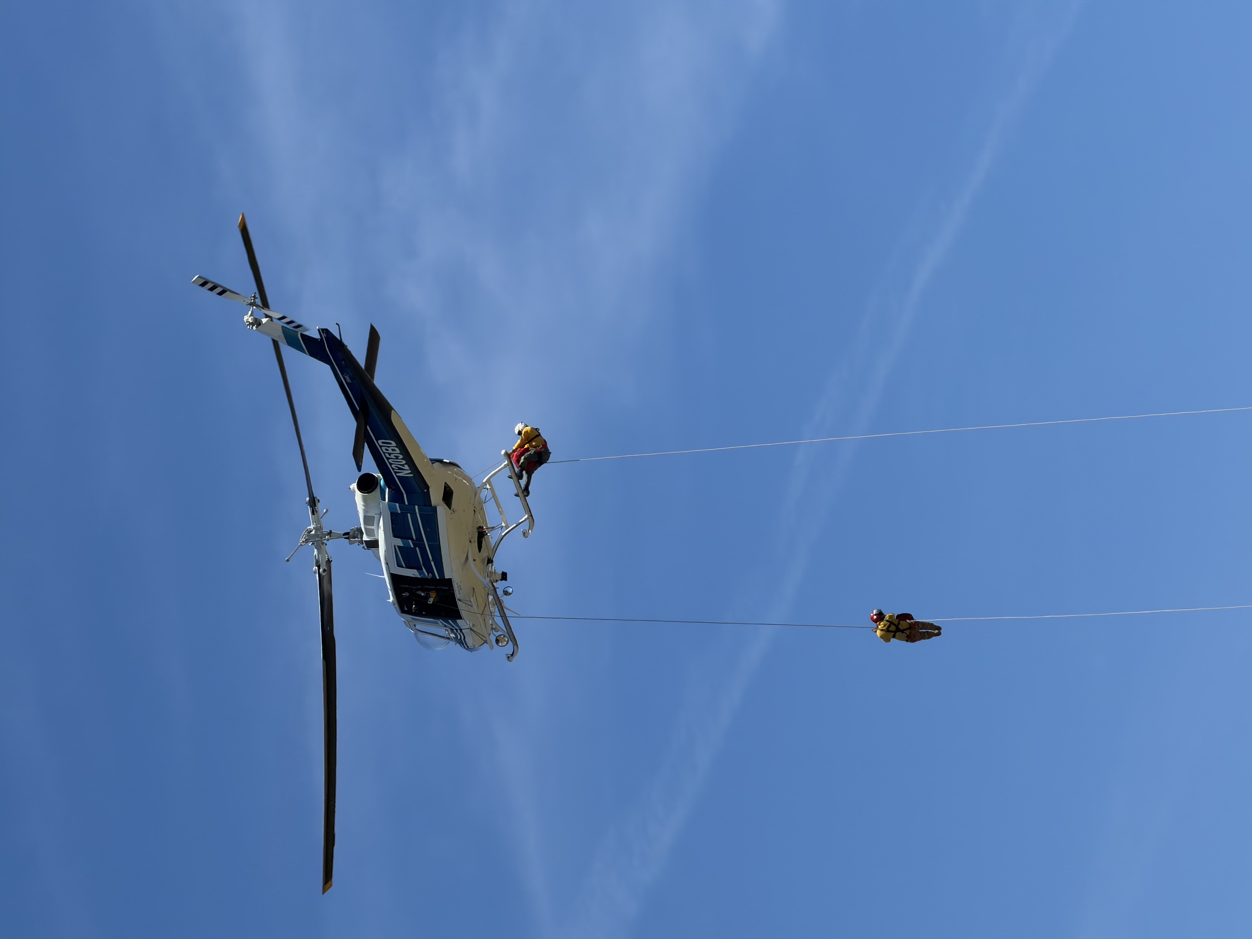 A pair of North Idaho Rappellers exit the skids and begin their descent during a live helicopter rappel operation.