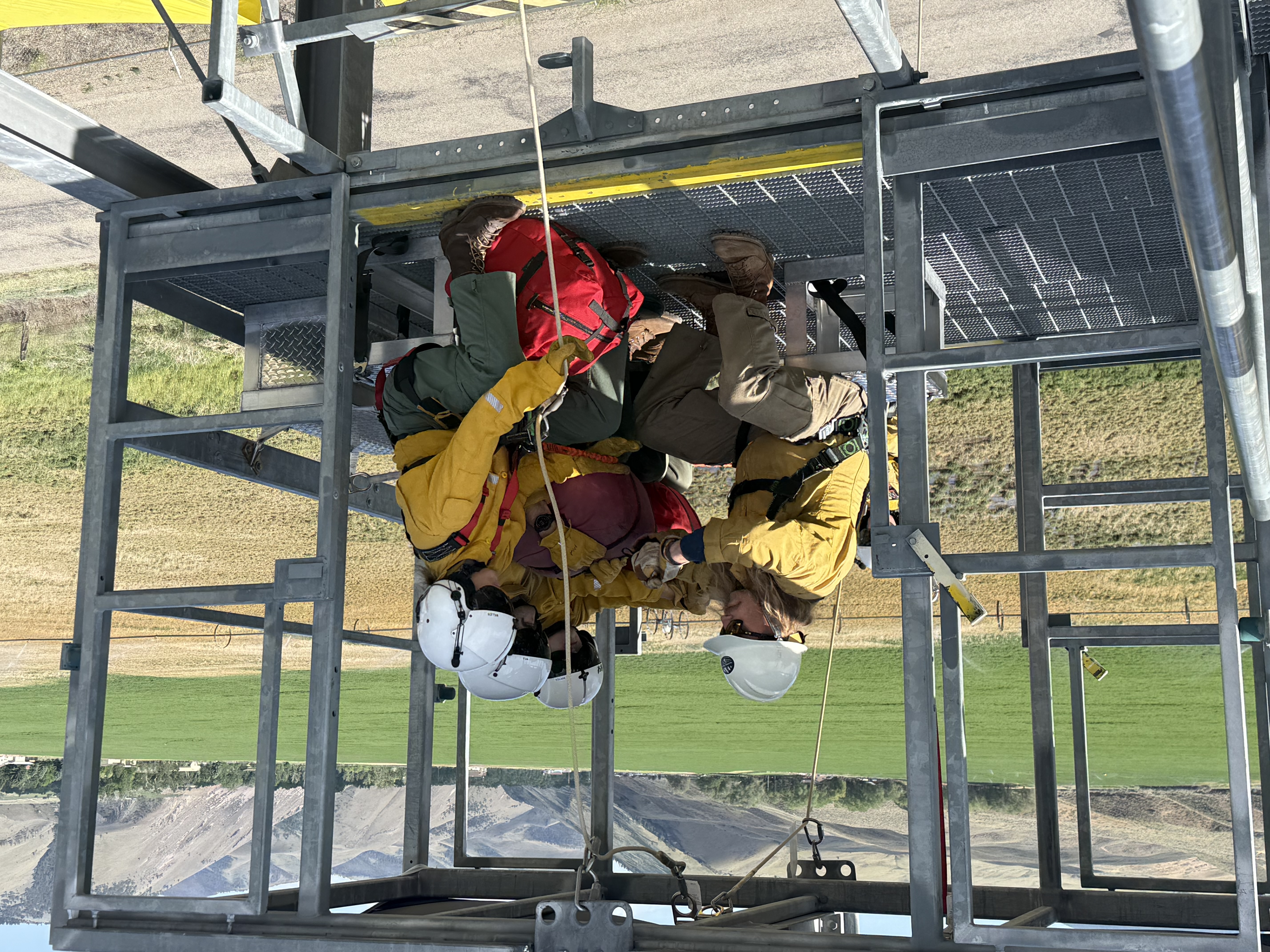 North Idaho Rappellers rookies practice helicopter cabin procedures and equipment checks during National Rappel Academy training in Salmon, Idaho.